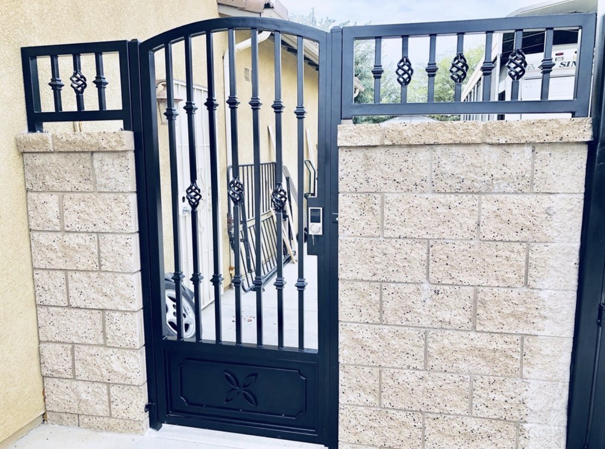 Black iron arched gate with basket twist accents