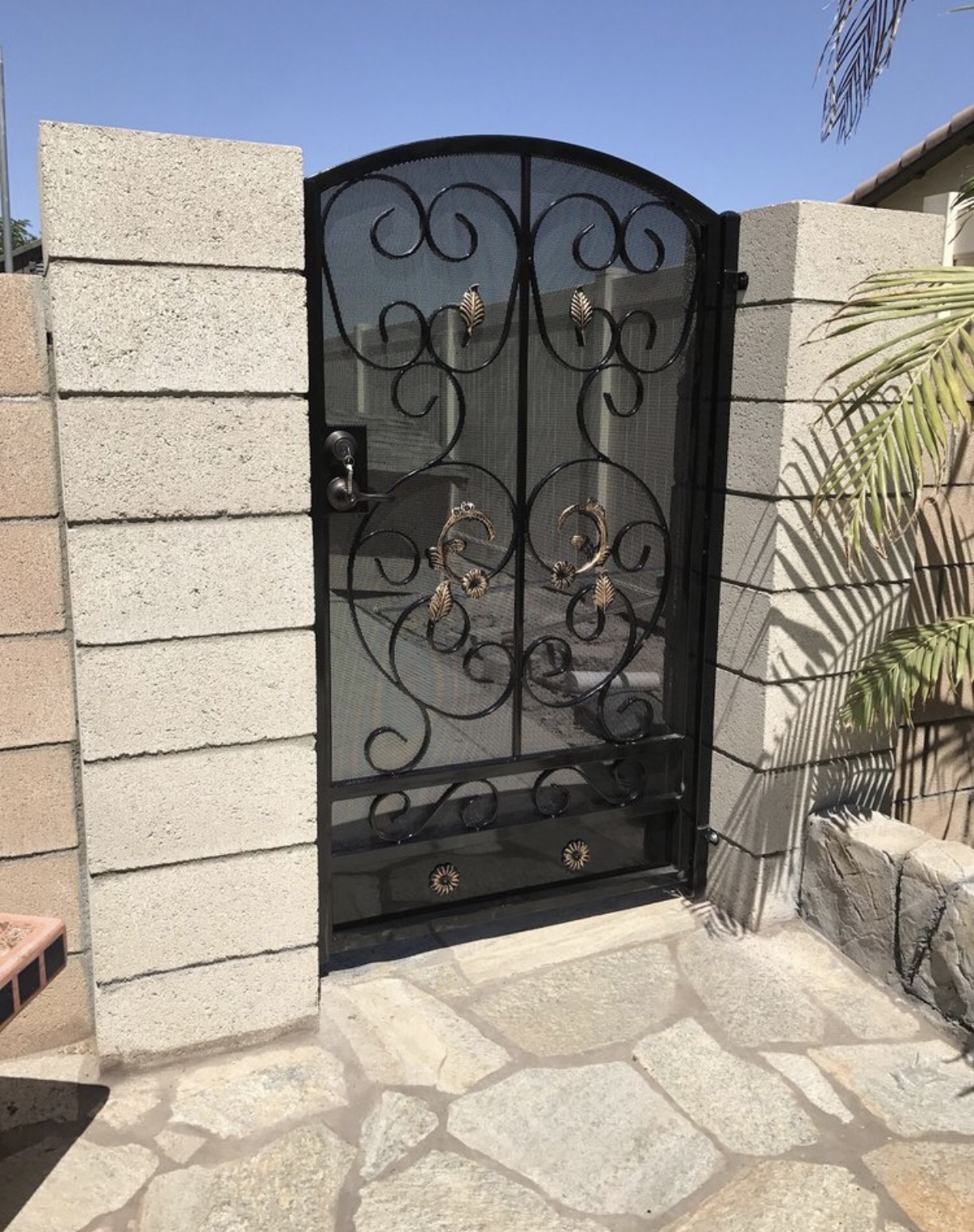 Black iron garden gate with leaf accents