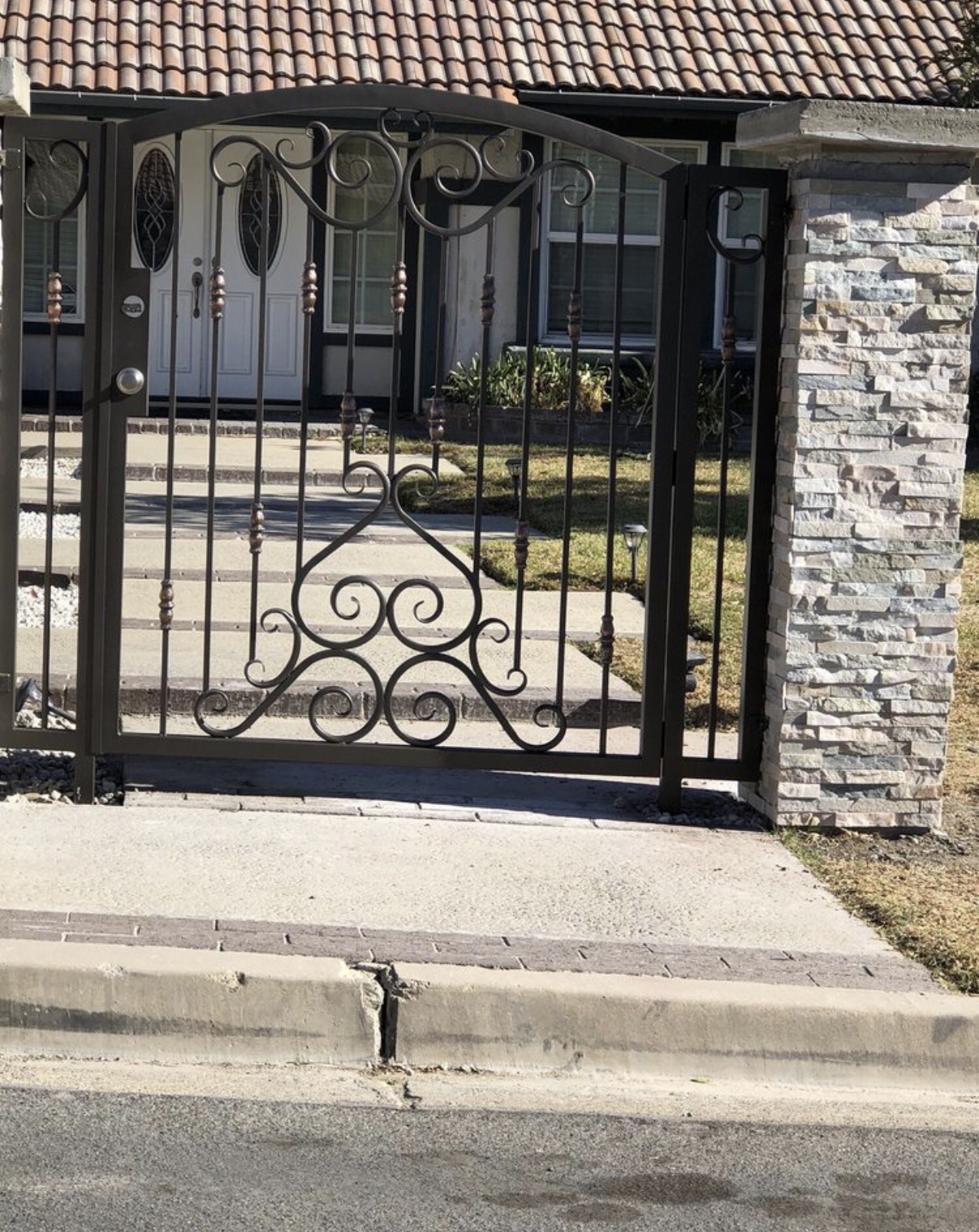 Bronze iron entry gate with center scrollwork