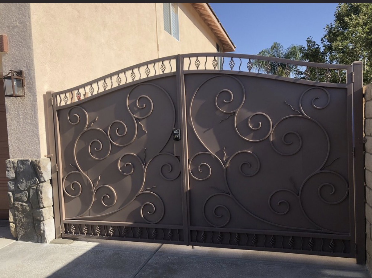 Bronze iron driveway gate with swirling scrollwork