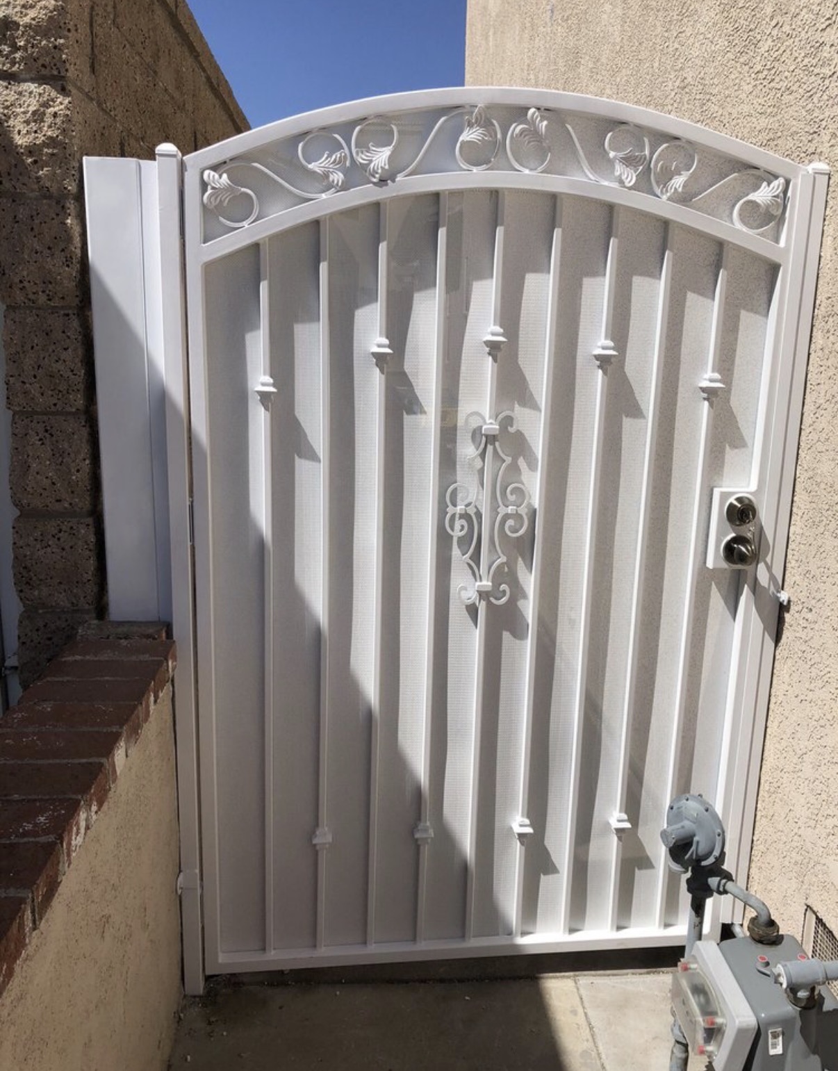 White iron arched side gate with leaf details
