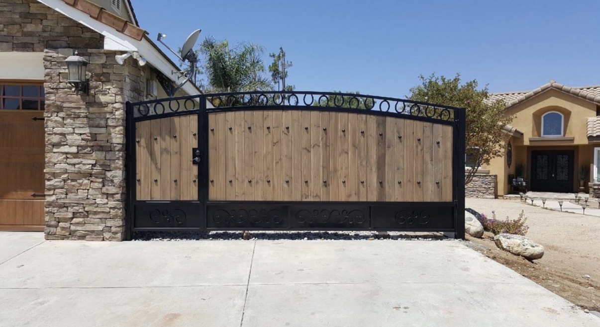 Wood and iron driveway gate with horseshoe arch detail