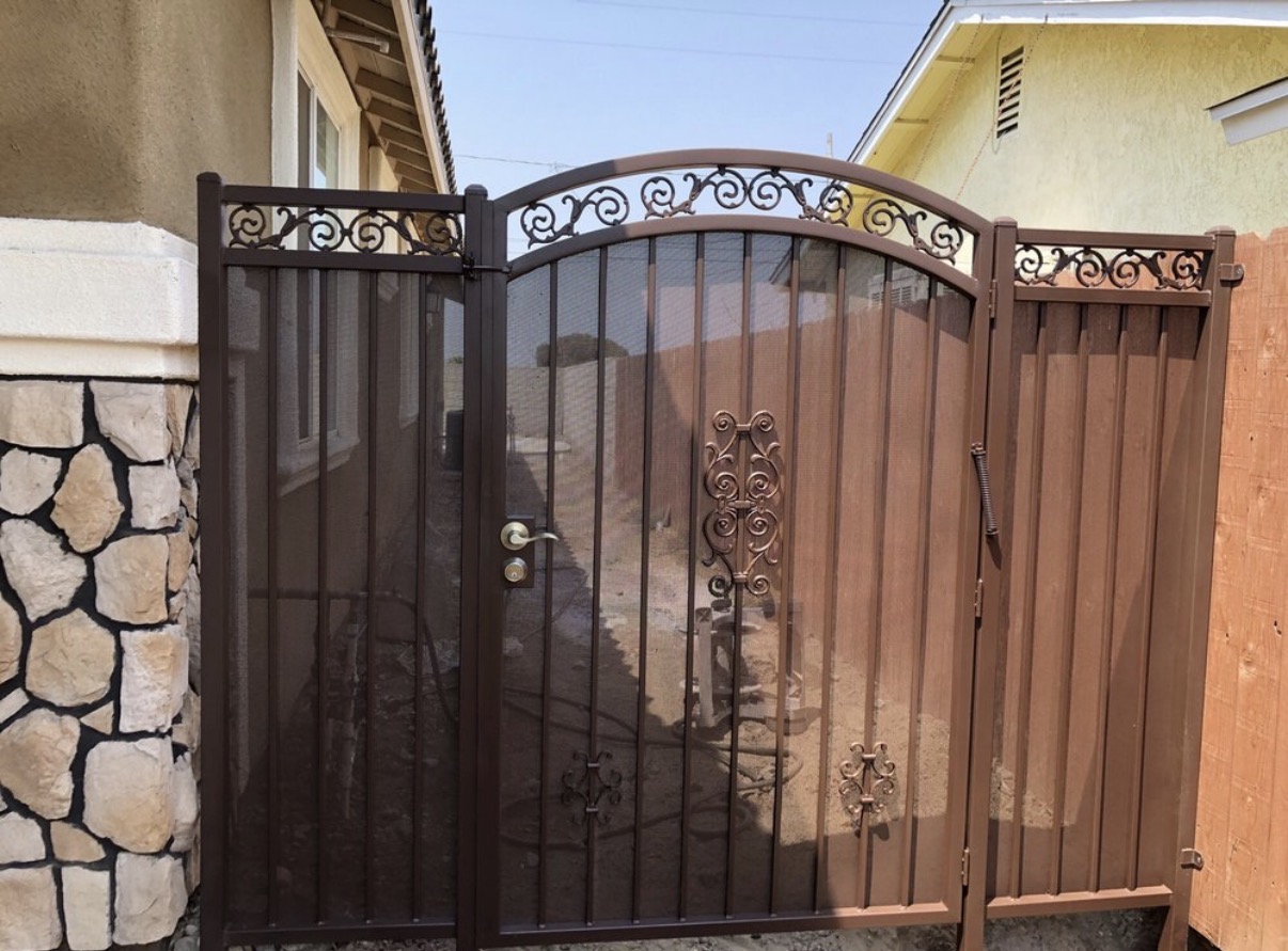 Bronze iron arched side gate with scrollwork crown