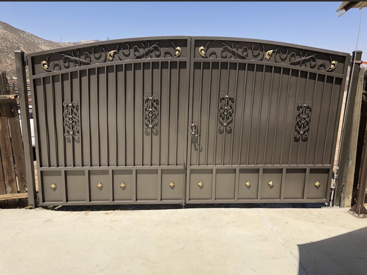 Bronze iron double driveway gate with gold scrollwork accents