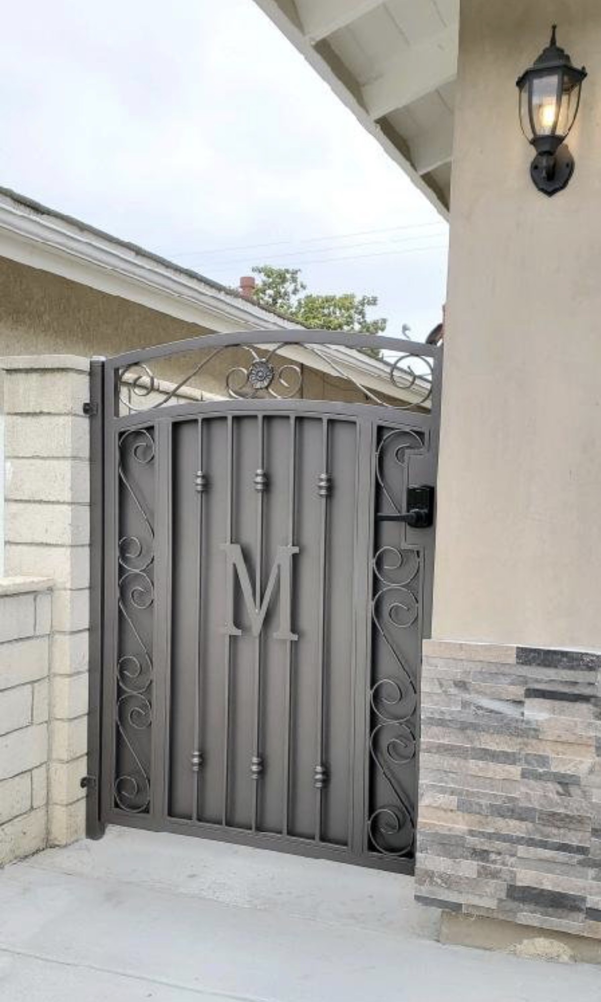 Custom iron pedestrian gate with monogram letter M