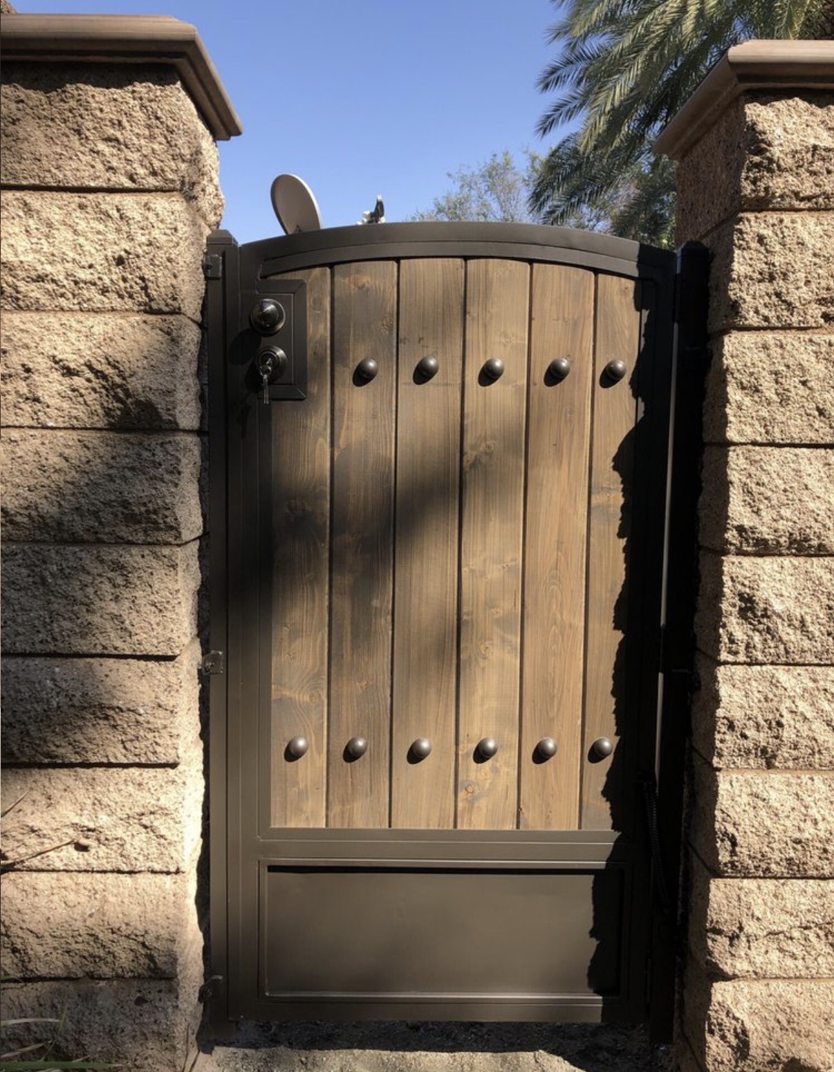 Rustic wood and iron arched side gate with studs