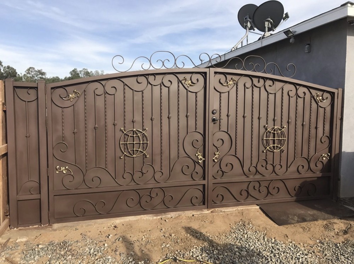 Ornate bronze iron double gate with globe medallions