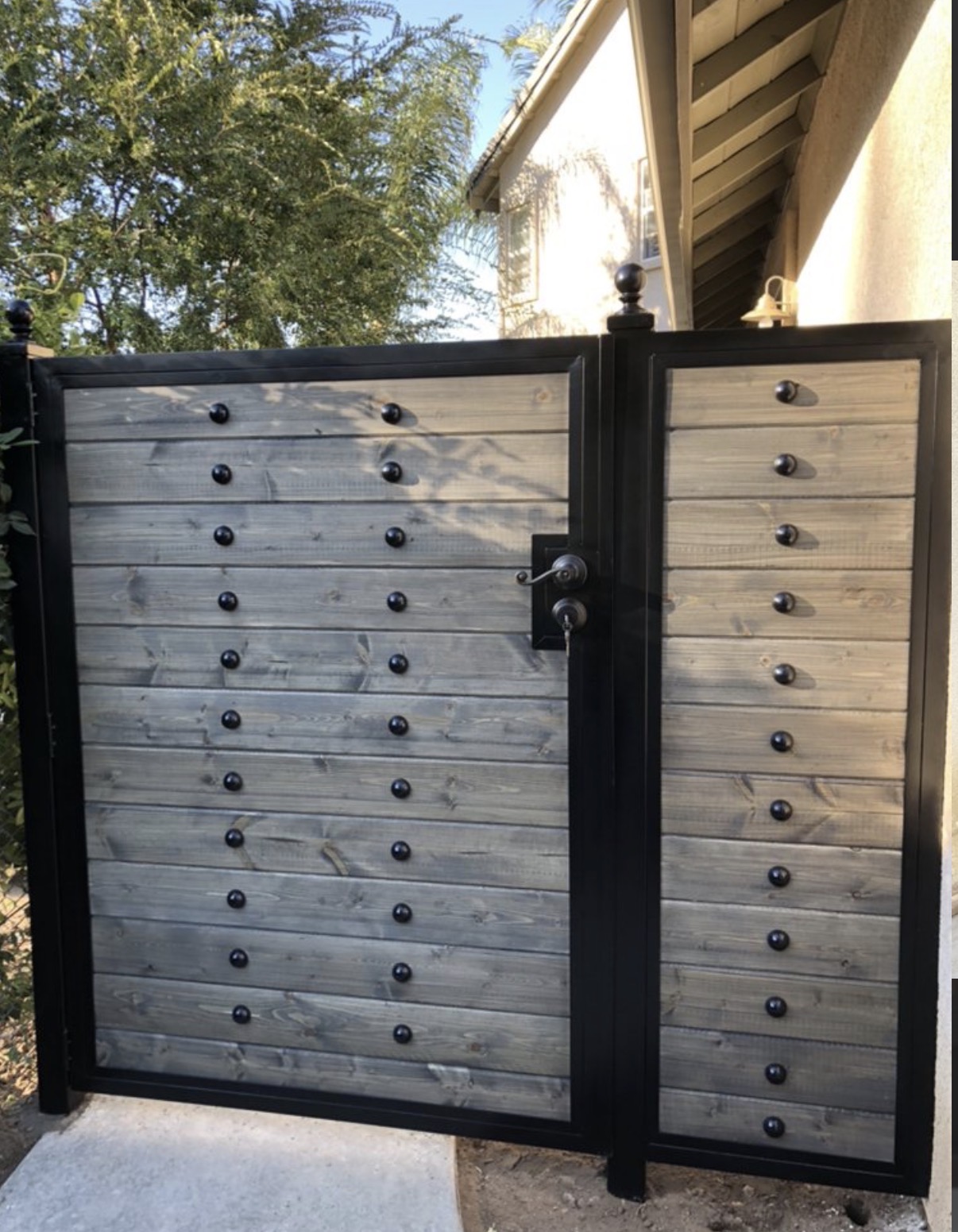 Modern horizontal wood gate with iron studs