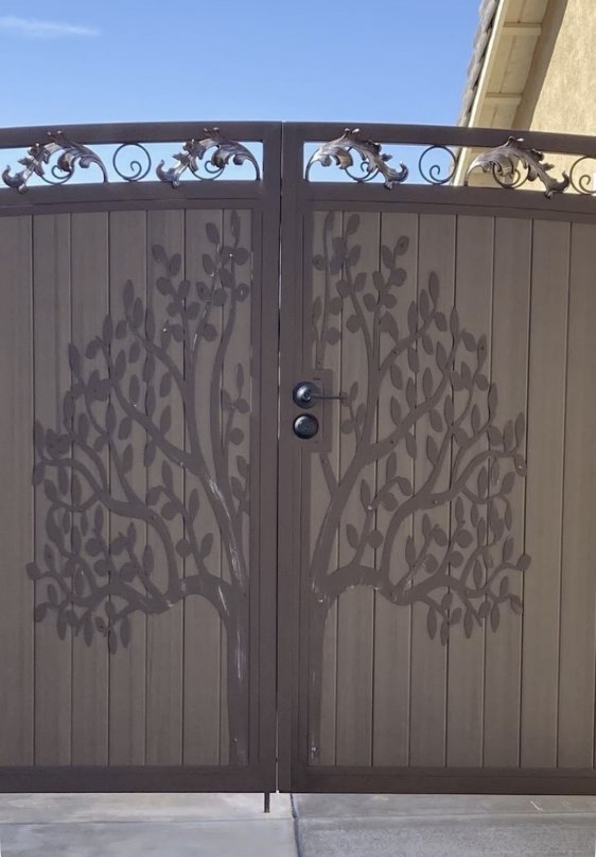 Bronze iron driveway gate with tree-of-life and leaf accents