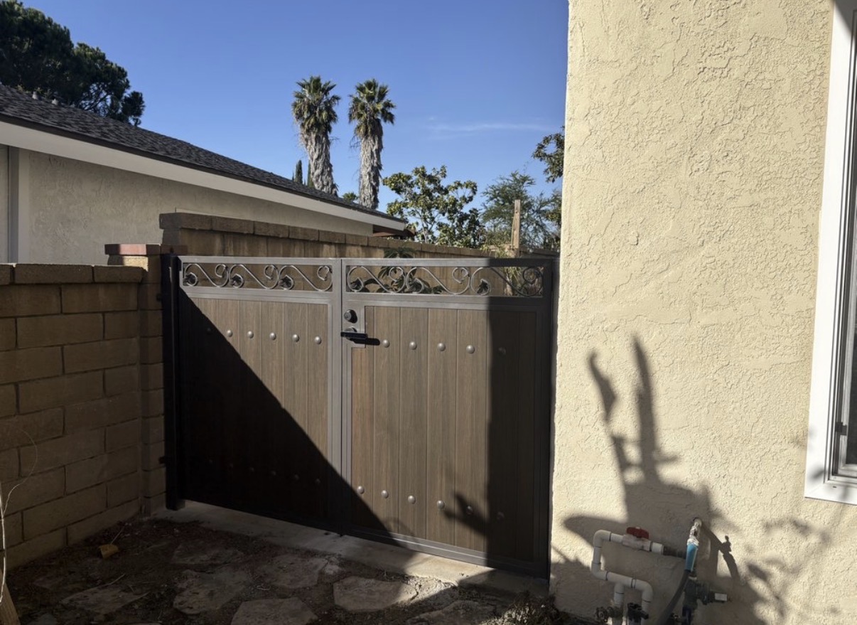 Wood-grain side gate with iron scrollwork crown and studs